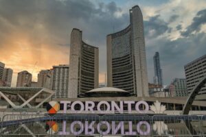 Skyline of Toronto with iconic city hall at sunset, captured at Nathan Phillips Square.