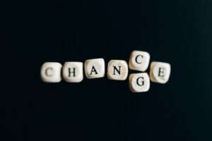 Letter dice forming the word 'Change' on a dark background, symbolizing transformation and opportunity.